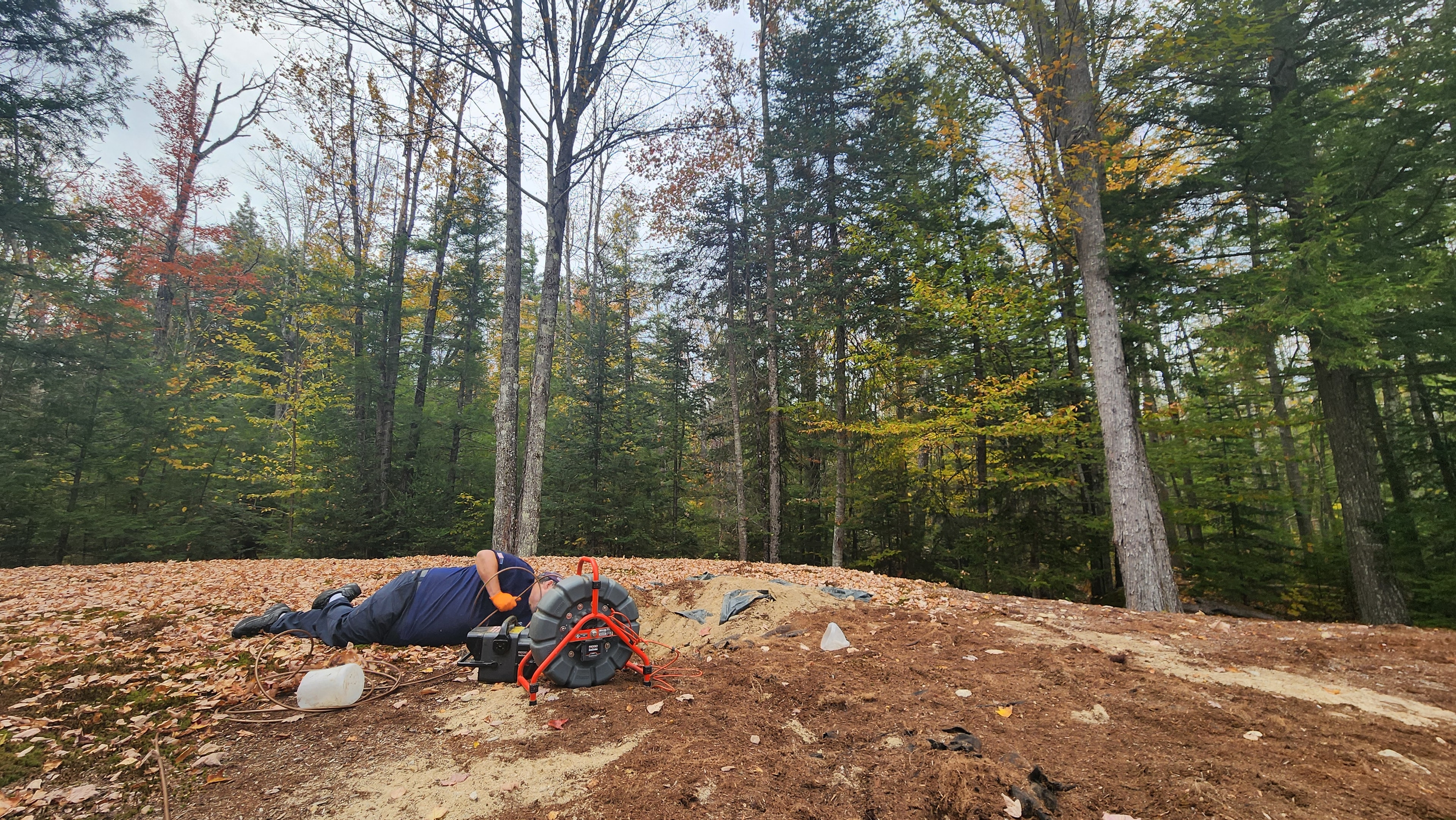 Technician performing camera inspection on sewer pipe